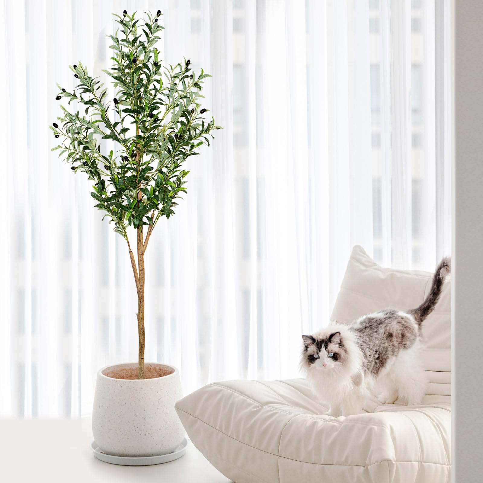 plantsworld faux olive tree staged in a modern living room to add greenery and style