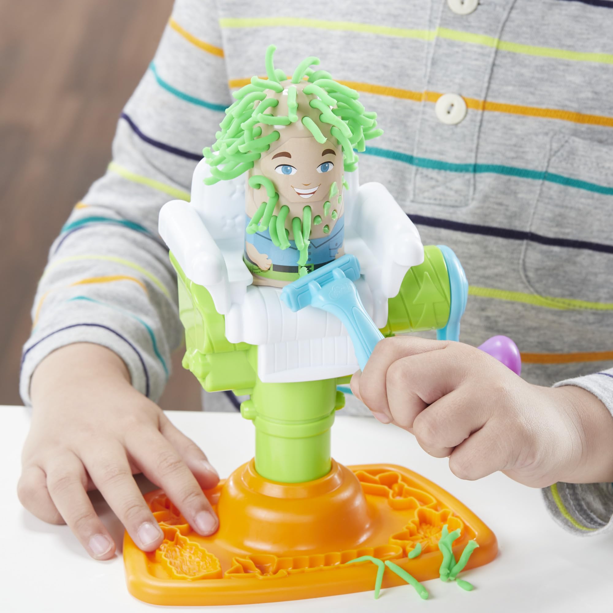 Play-Doh two character heads before and after haircut demonstrating transformation
