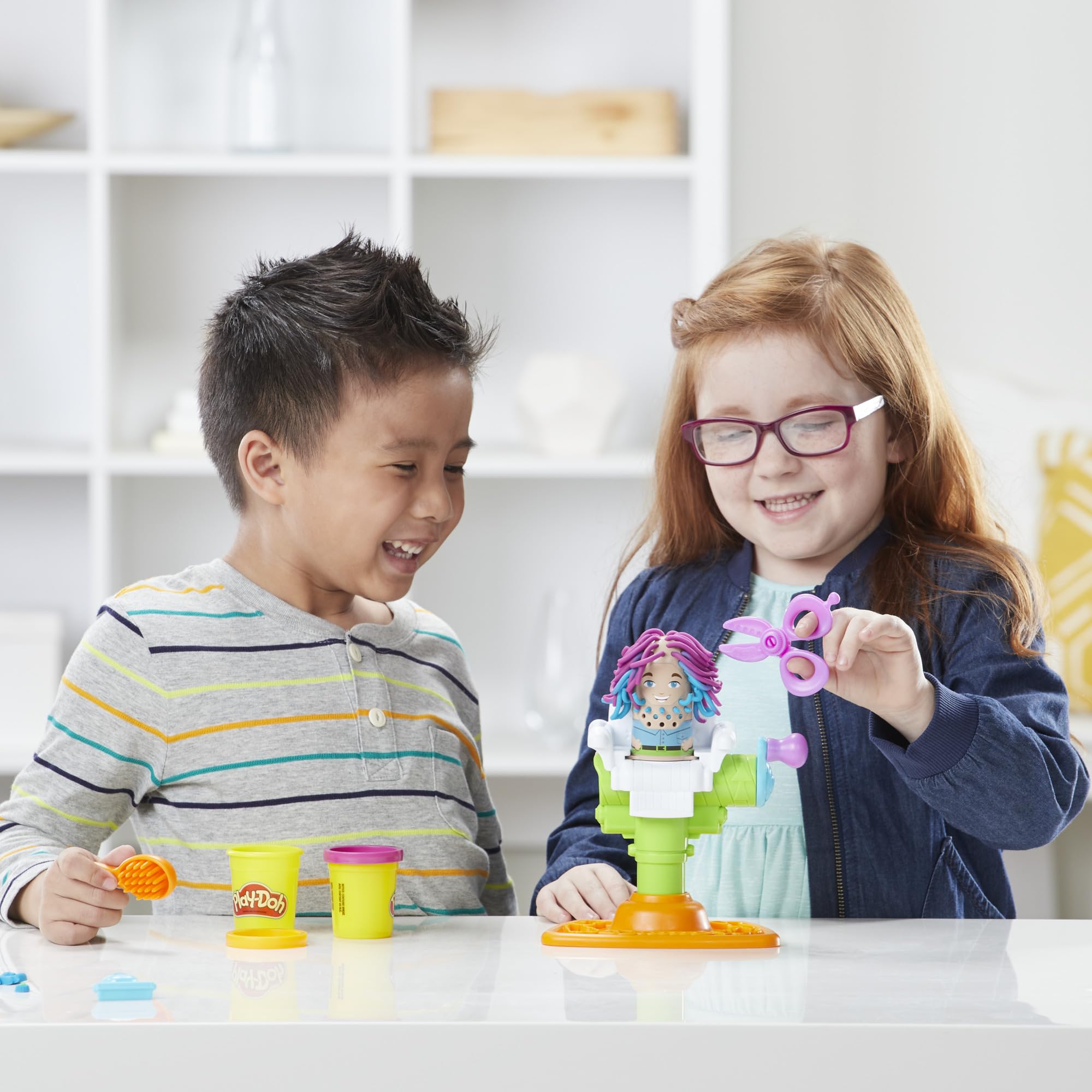 Play-Doh child using tools to style a character showcasing hands-on creativity