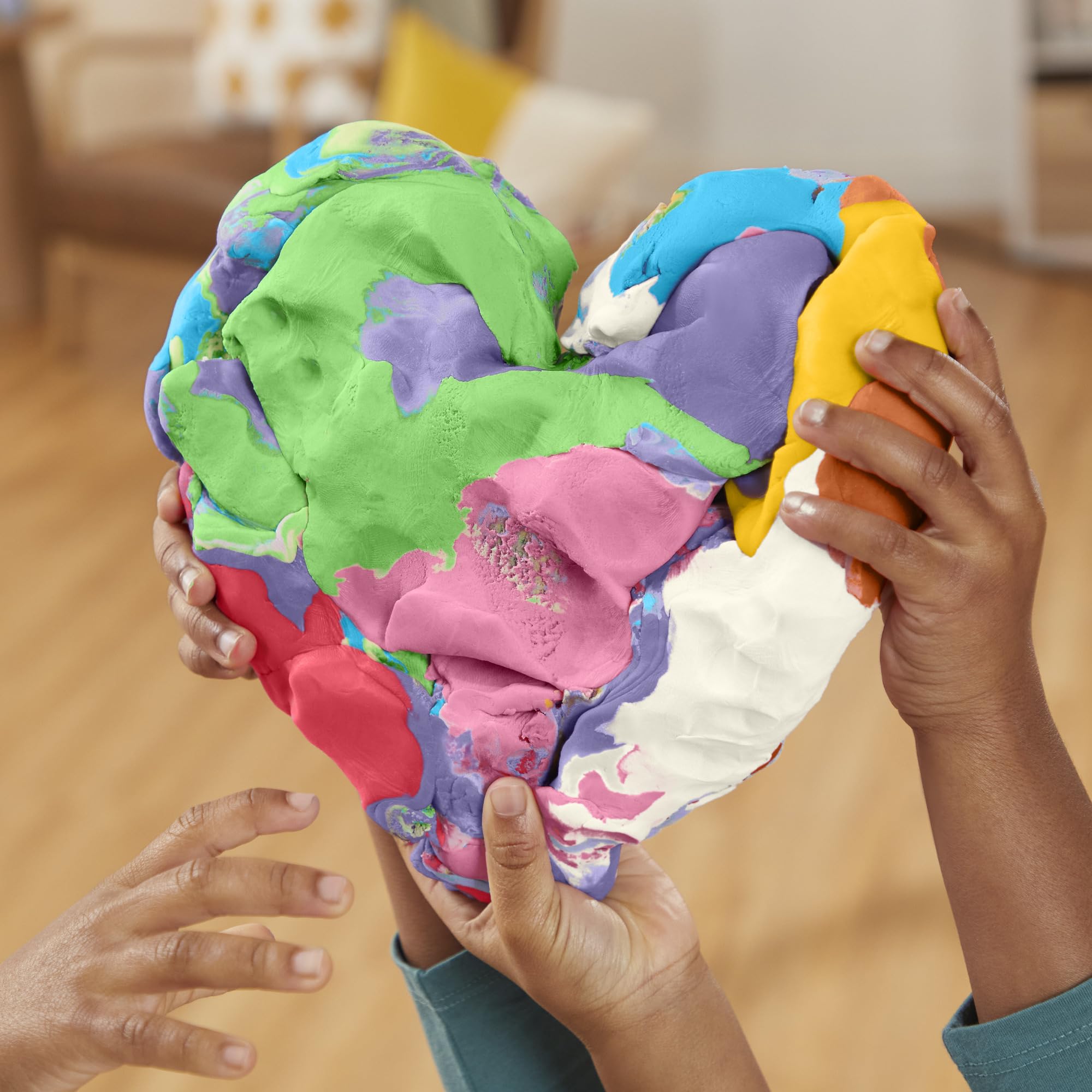Hands shaping Play‑Doh to develop fine motor skills and creative expression