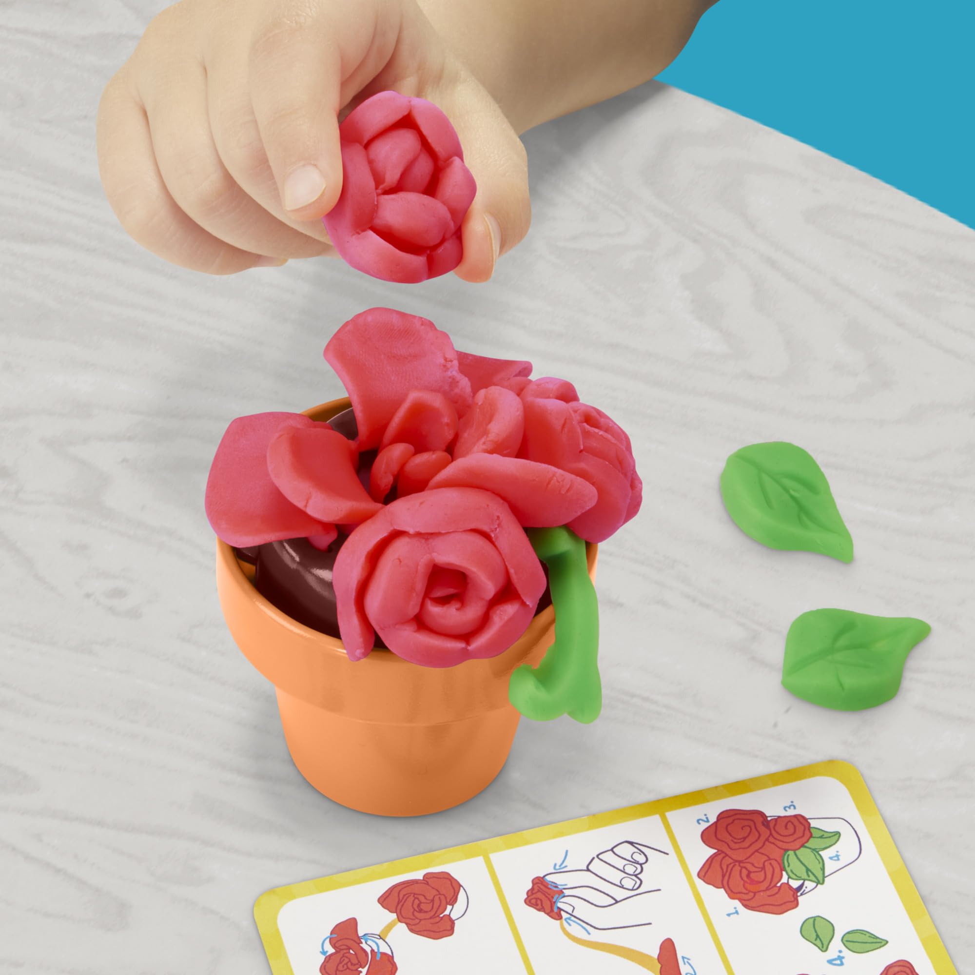 Children playing with Play‑Doh Blooming Flower Garden indoors encouraging creativity