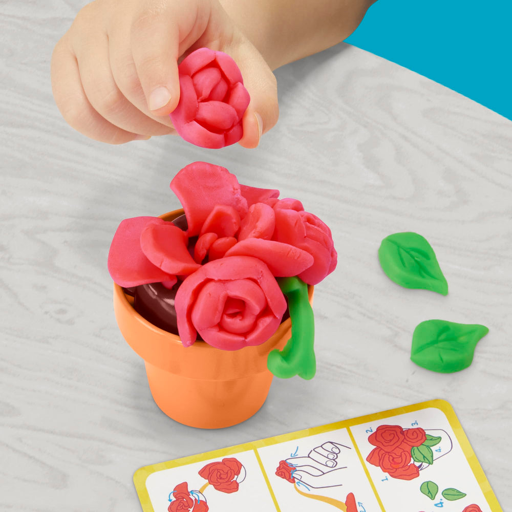 Children playing with Play‑Doh Blooming Flower Garden indoors encouraging creativity