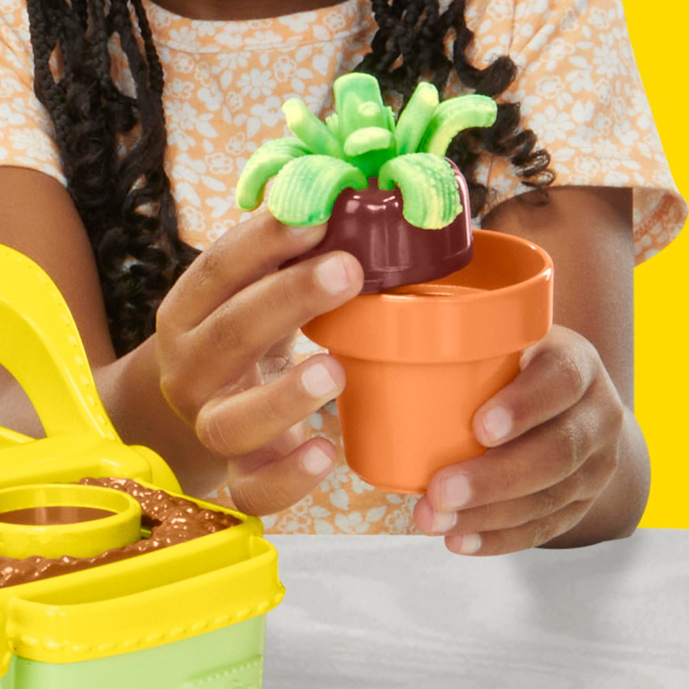 Garden box used as a carrying and storage case for Play‑Doh tools and dough