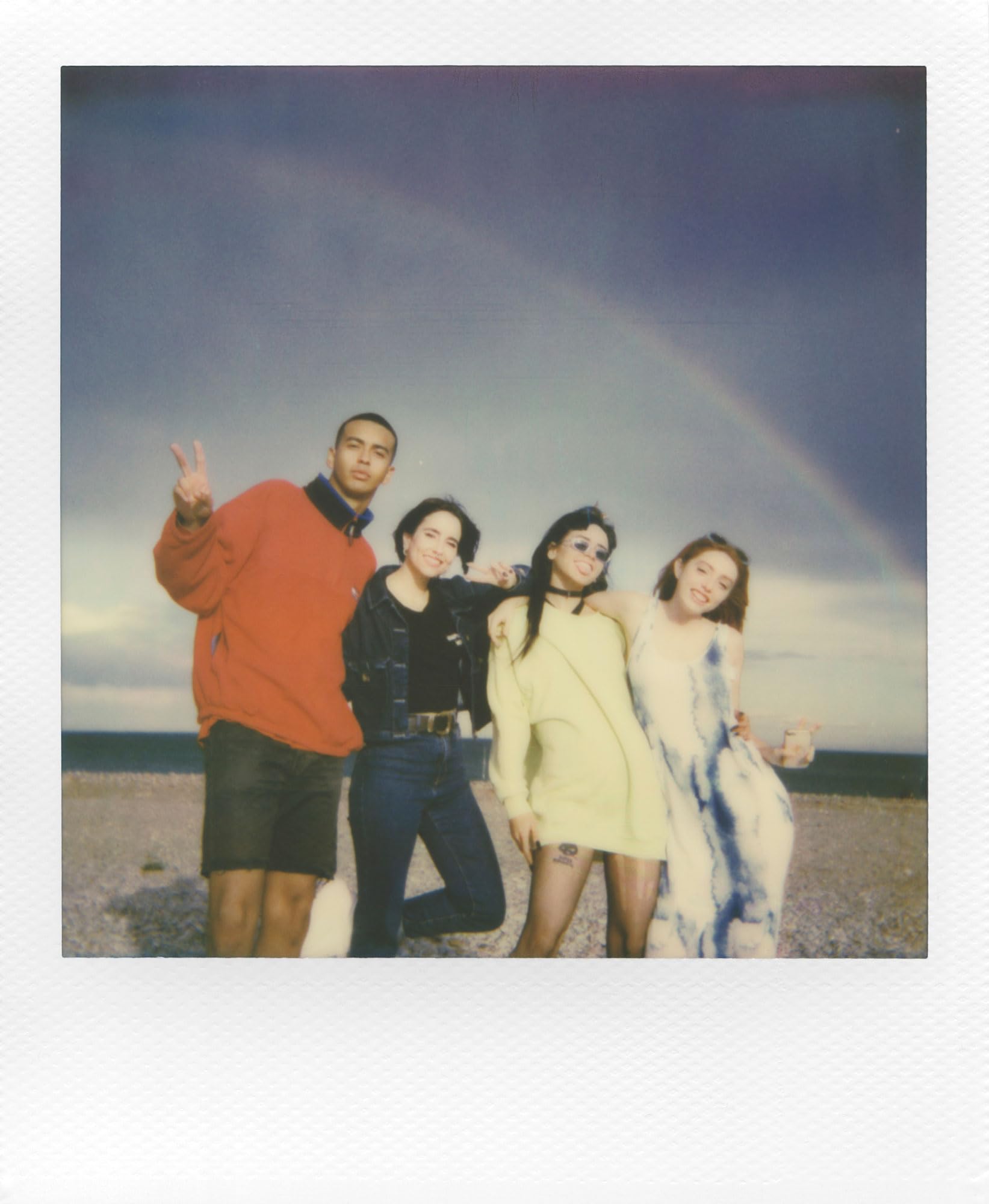 Polaroid film ejecting from camera demonstrating instant print emergence and excitement