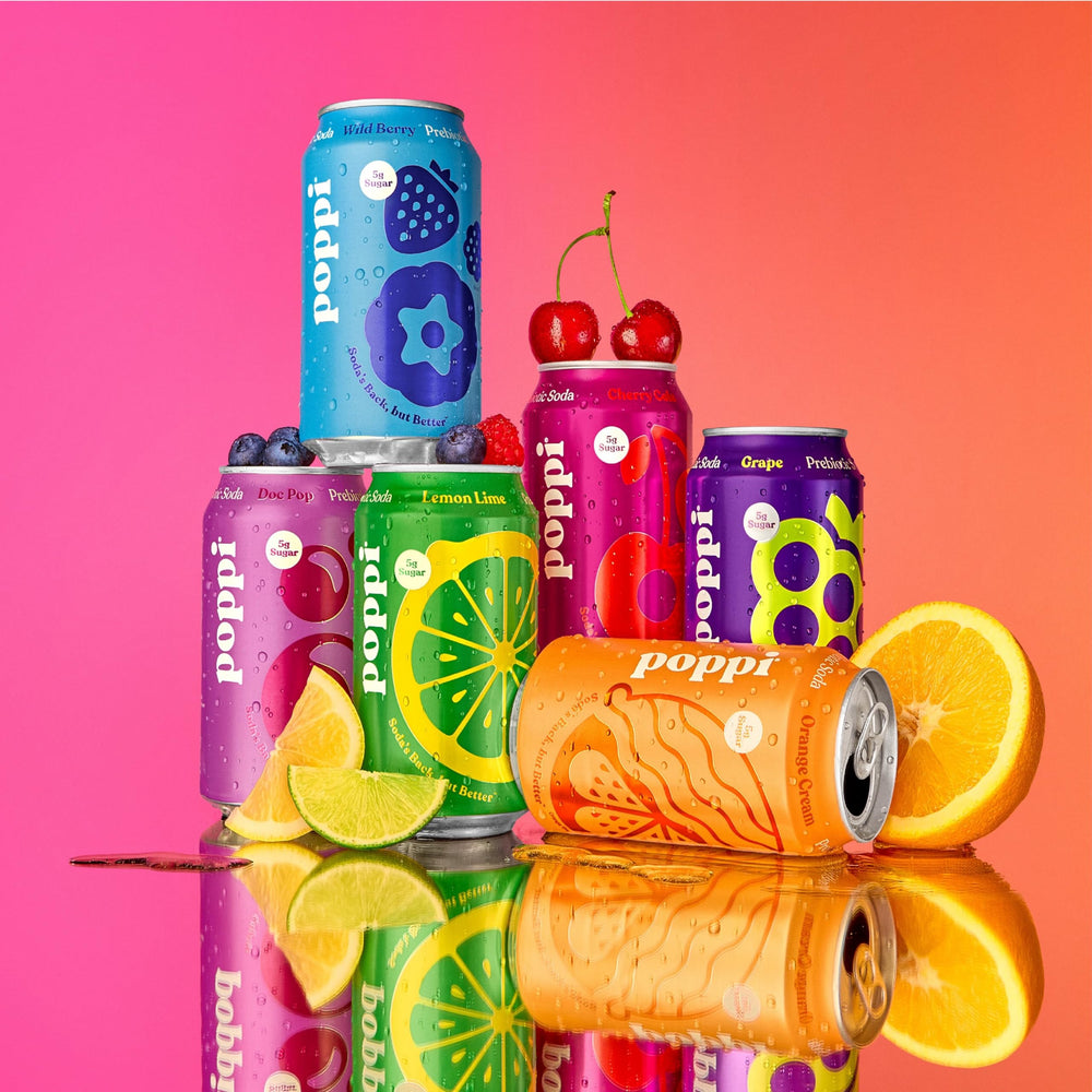 All Poppi flavors from the pack arranged to show Lemon Lime, Grape, Orange Cream, Cherry Cola, Wild Berry, Doc Pop