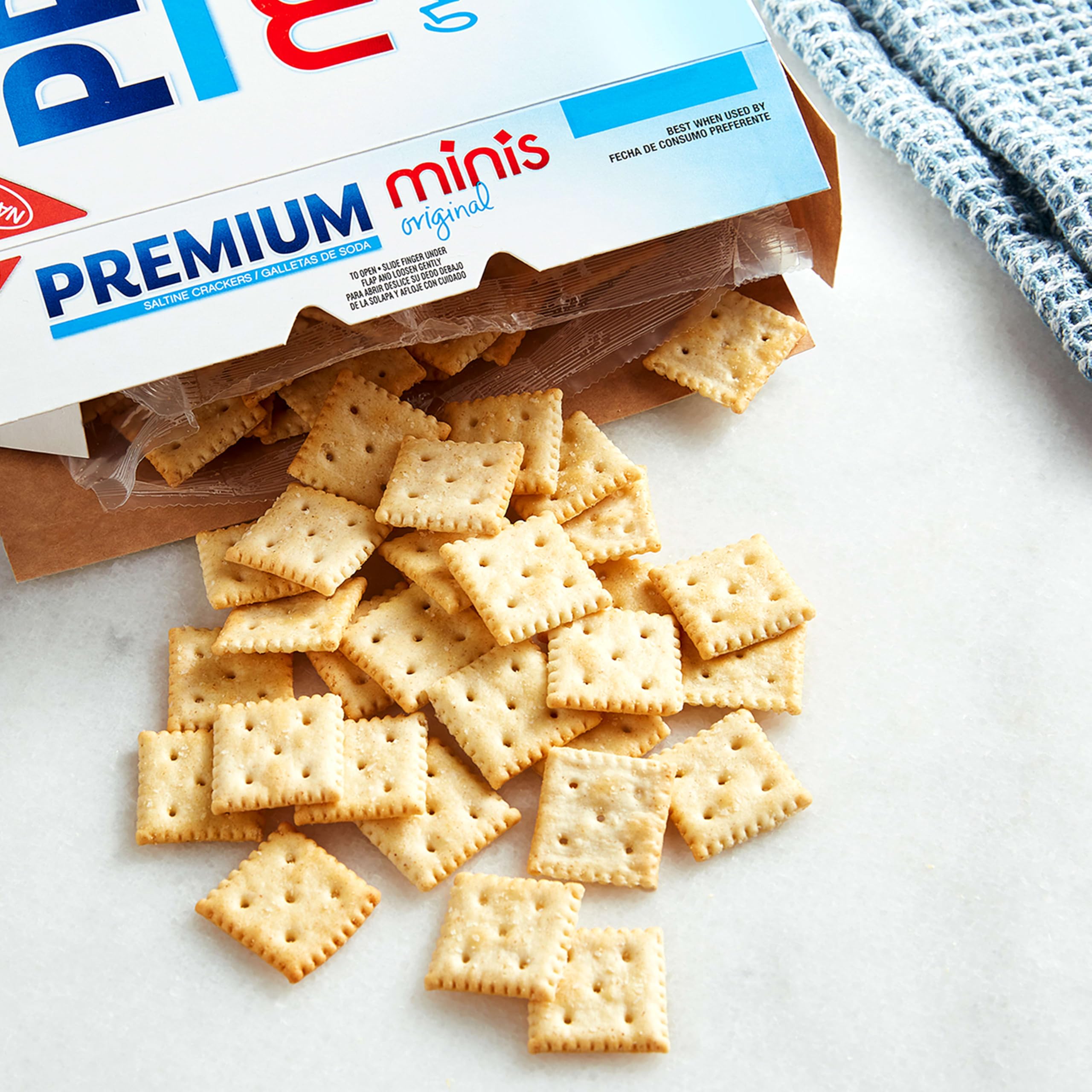 Premium mini saltine single cracker in hand for easy, portable snacking