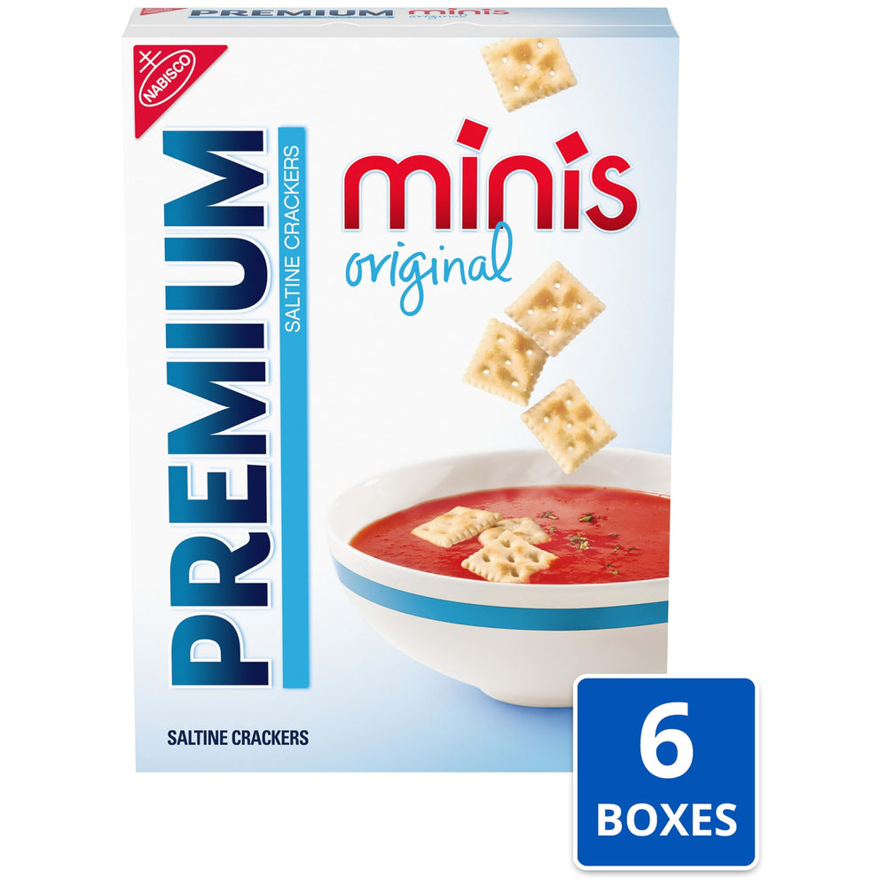Premium mini saltine stack next to coin for scale showing small size benefit