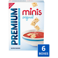 Premium mini saltine stack next to coin for scale showing small size benefit
