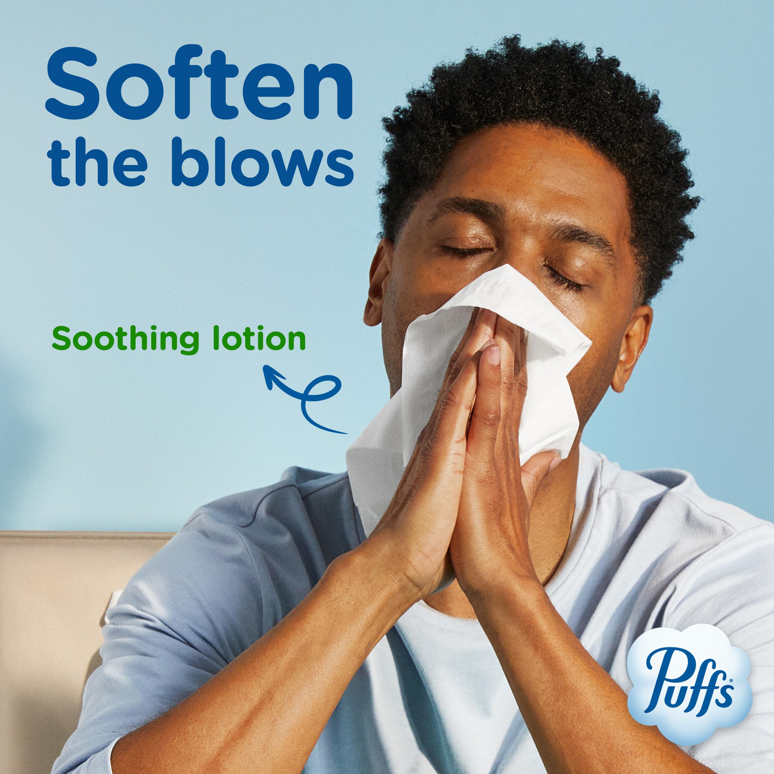 Hand holding a Puffs tissue, demonstrating soft, lotion-coated feel