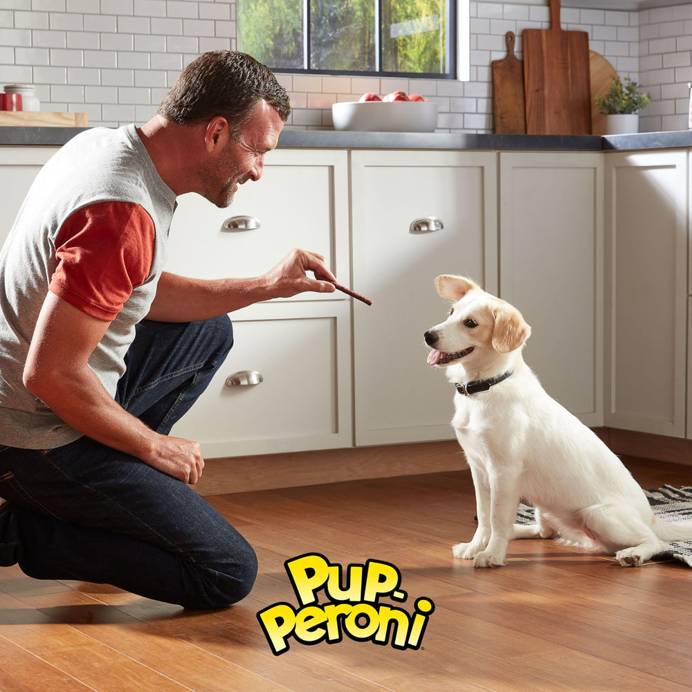Hand holding a Pup-Peroni treat demonstrating easy portioning