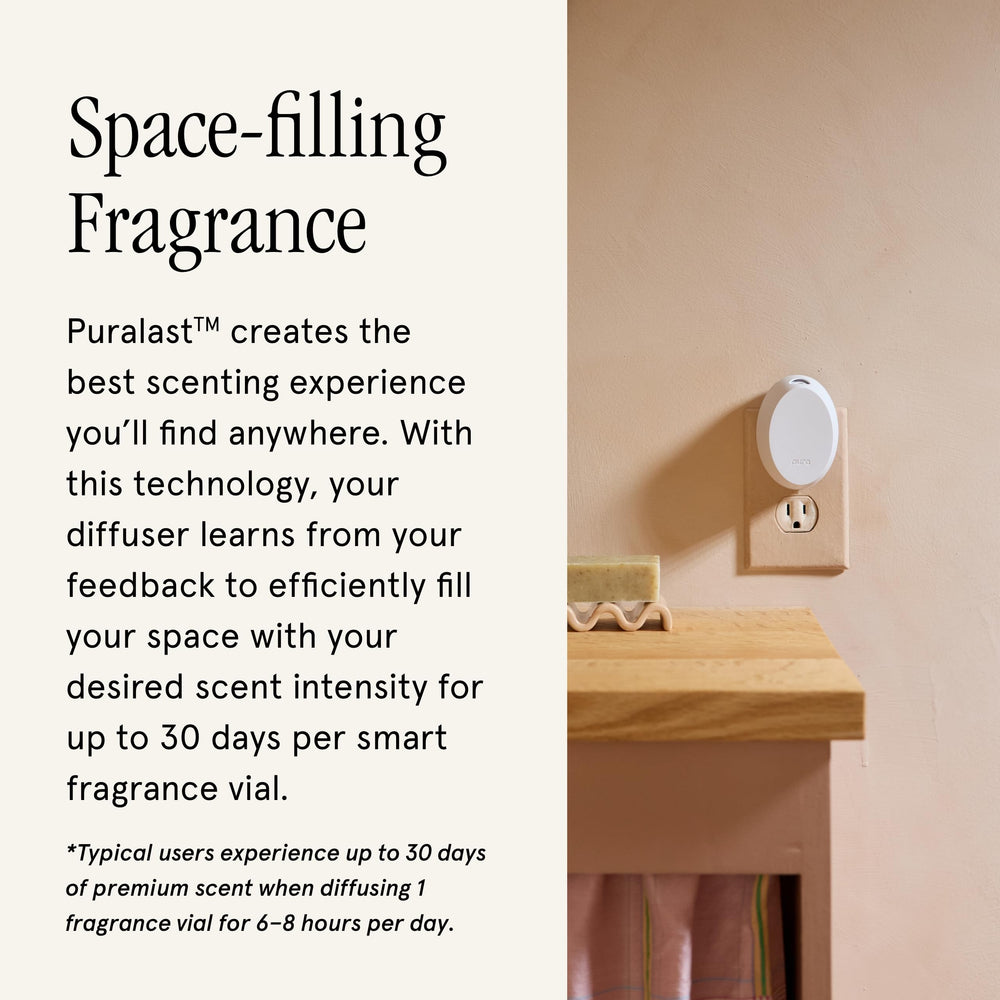 Pura mini with smartphone in hand controlling app, showing smart scheduling convenience