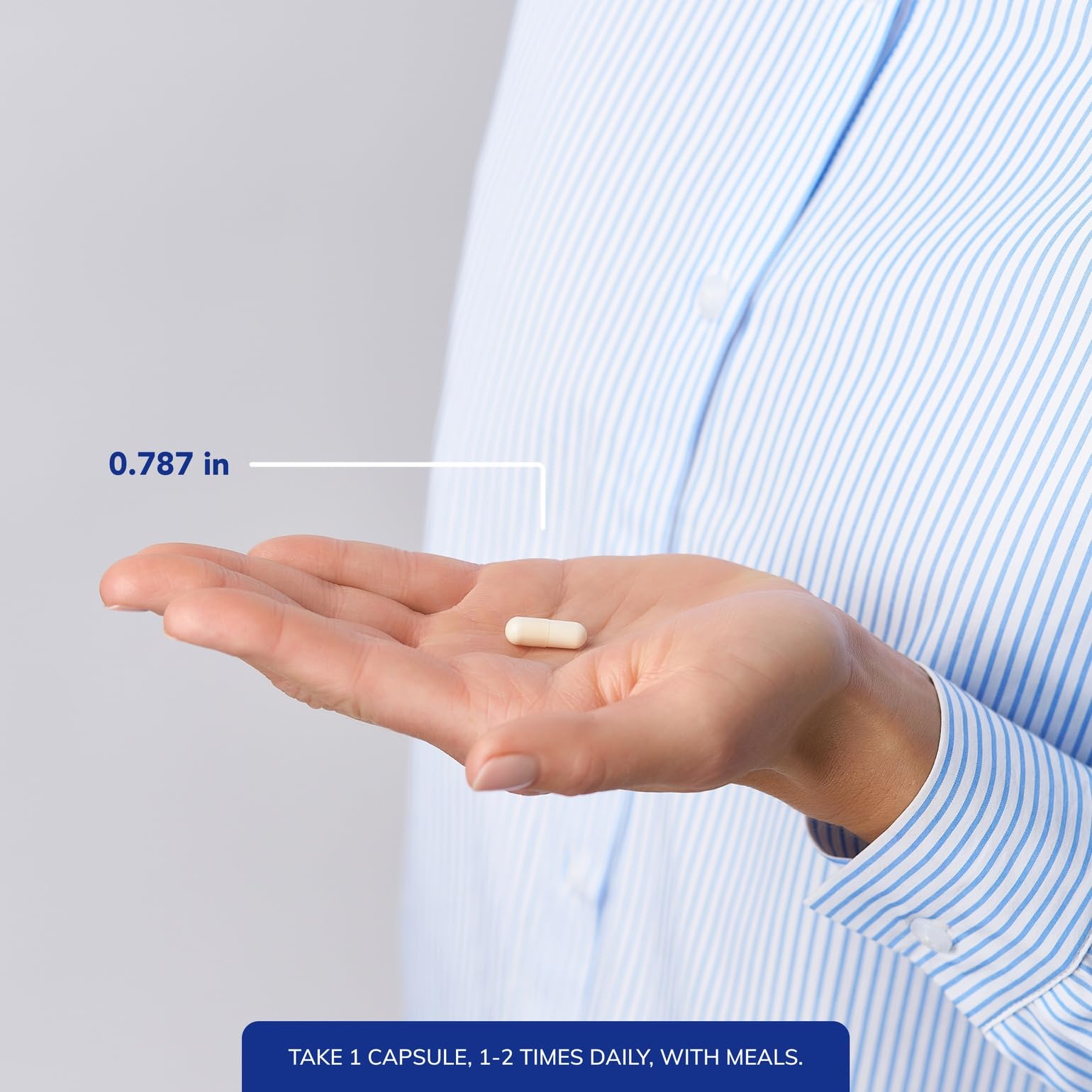 Pure Encapsulations capsule next to a coin for scale indicating compact size