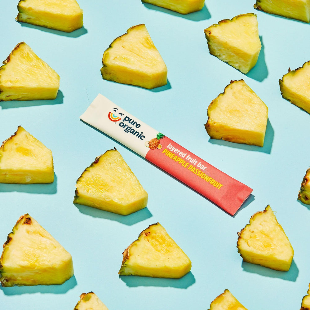 Pure Organic bar displayed with pineapple and passionfruit ingredients for transparency