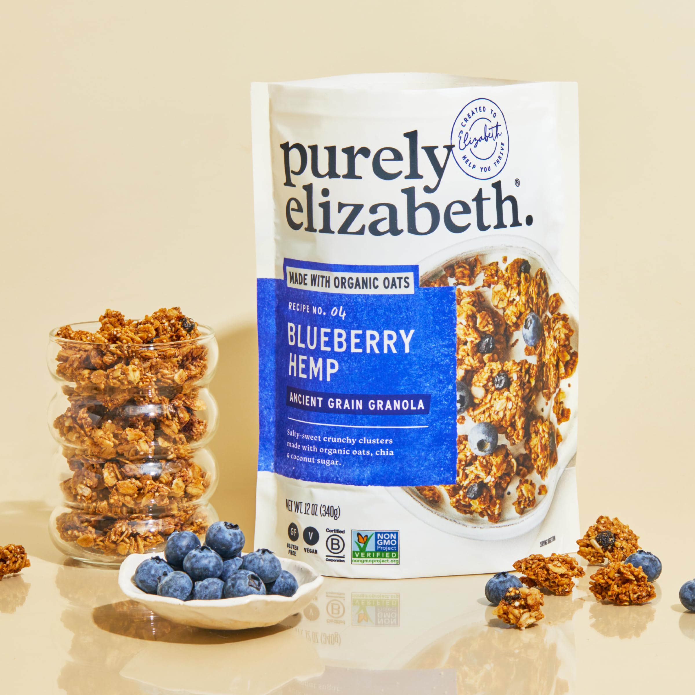 Purely Elizabeth spoon sprinkling granola over yogurt for added crunch