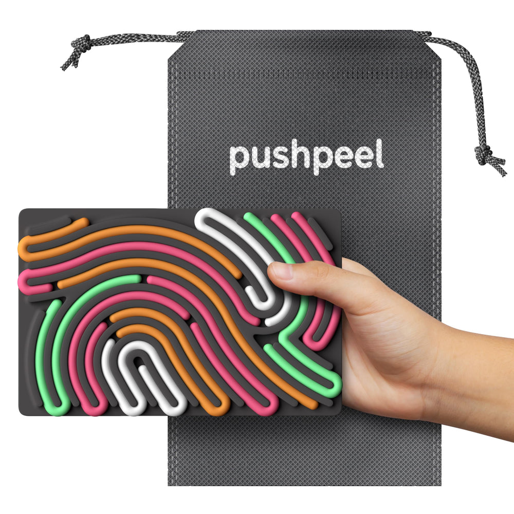 Pushpeel size comparison with hand showing compact scale for travel convenience