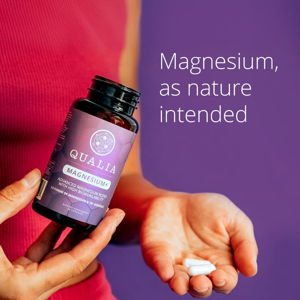 Hand holding Qualia Magnesium+ capsule illustrating daily use