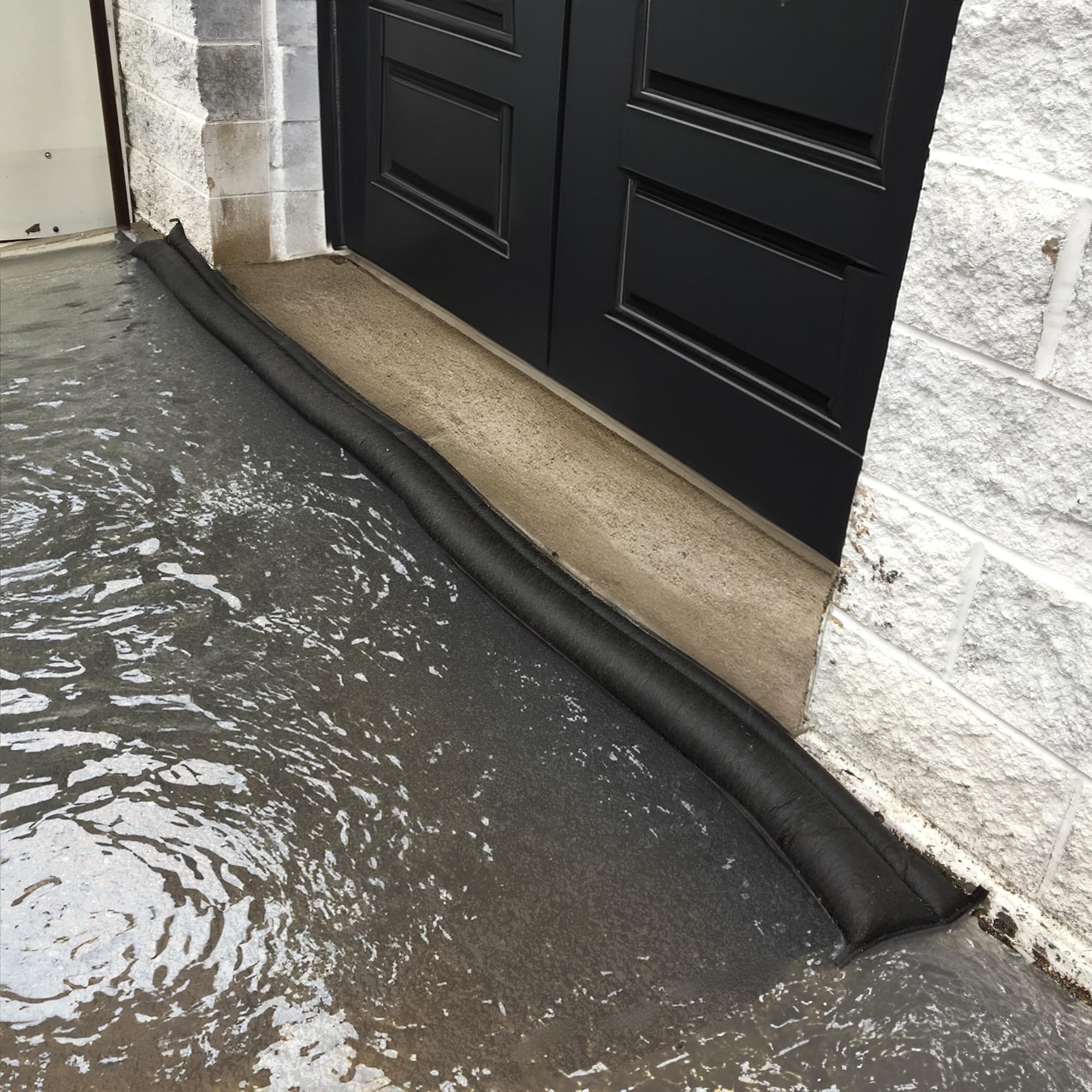 Quick Dam placed at garage threshold blocking water to protect interiors