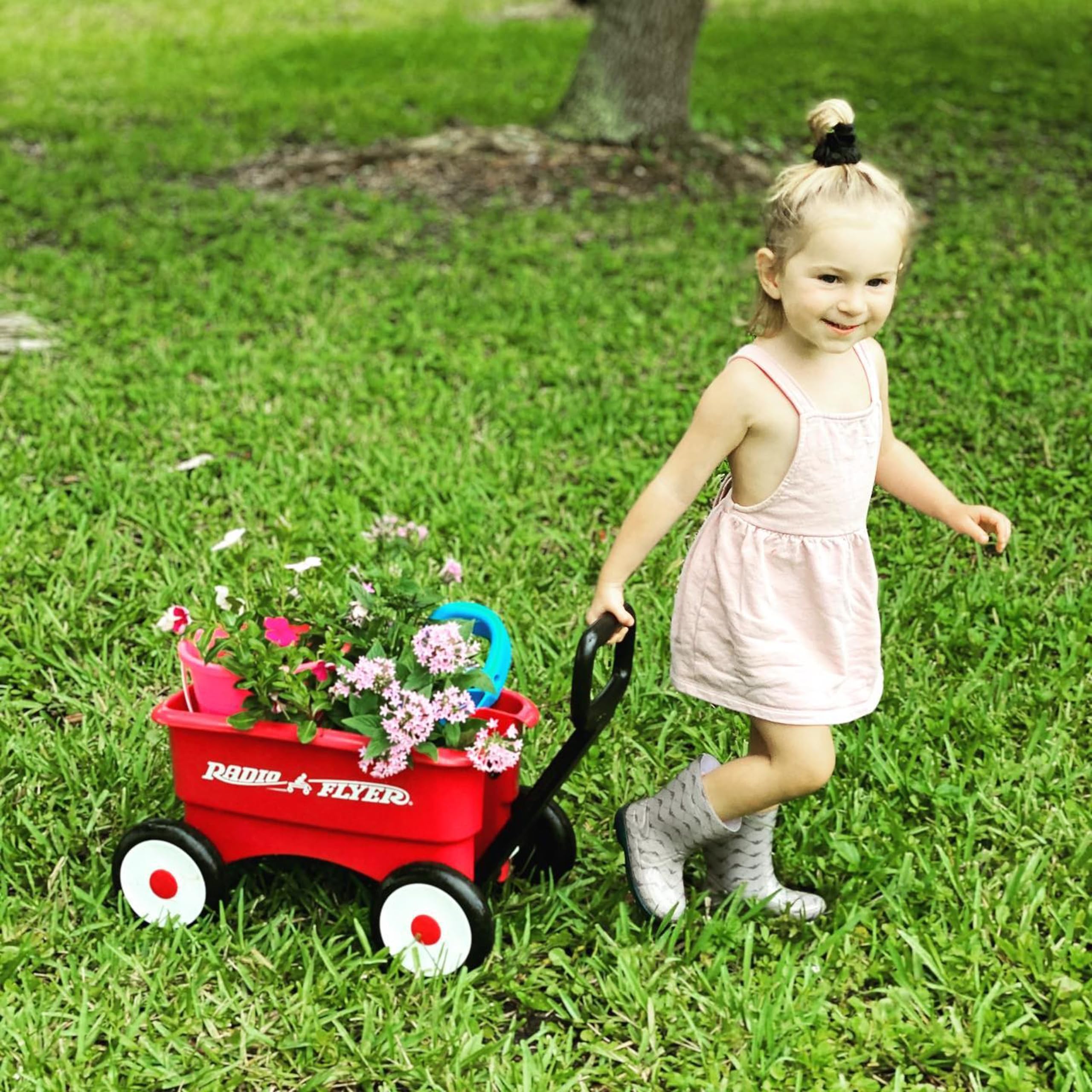 Radio Flyer being pushed by toddler indoors highlighting balance support and confidence building