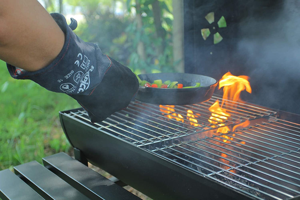 RAPICCA gloves handling hot coals at a firepit for safe use