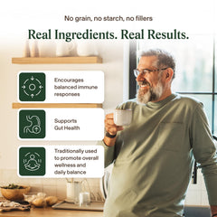 Real Mushrooms capsule opened on scoop showing extract contents and potency