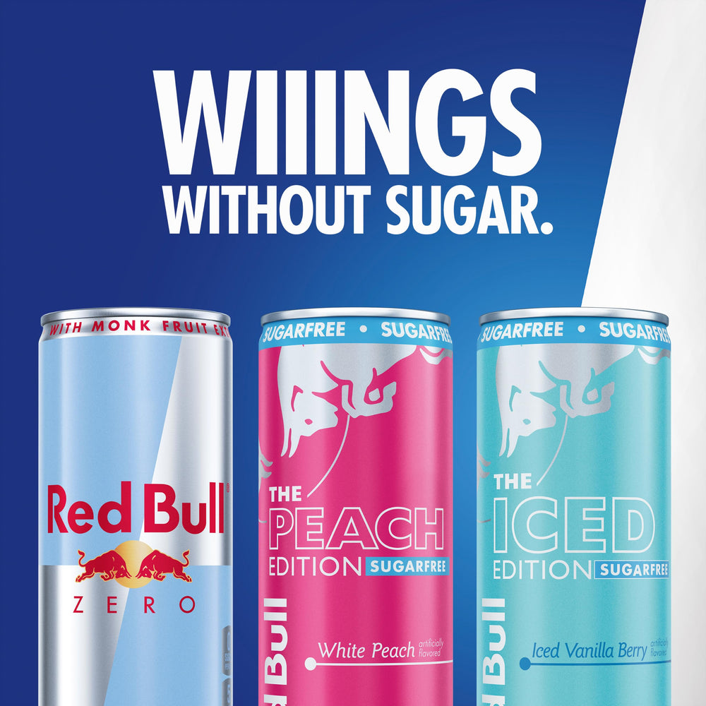 Red Bull can next to smartphone for scale showing slim can convenience and on-the-go use