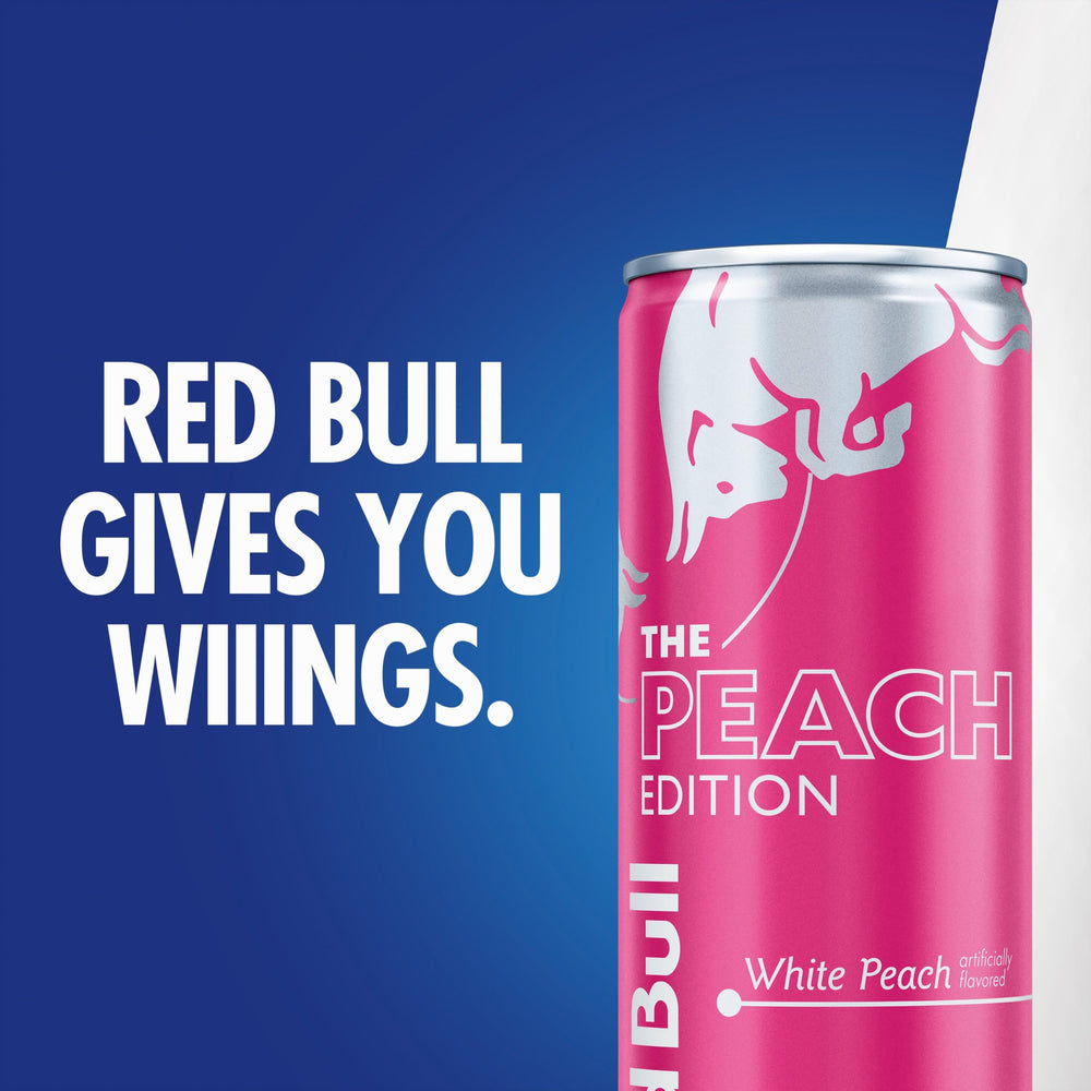 Red Bull White Peach can held in hand showing 8.4 fl oz size and portability