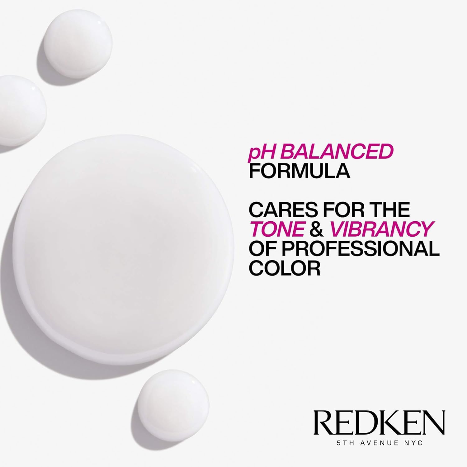 Redken 33.8 fl oz bottle beside hand for scale showing value size