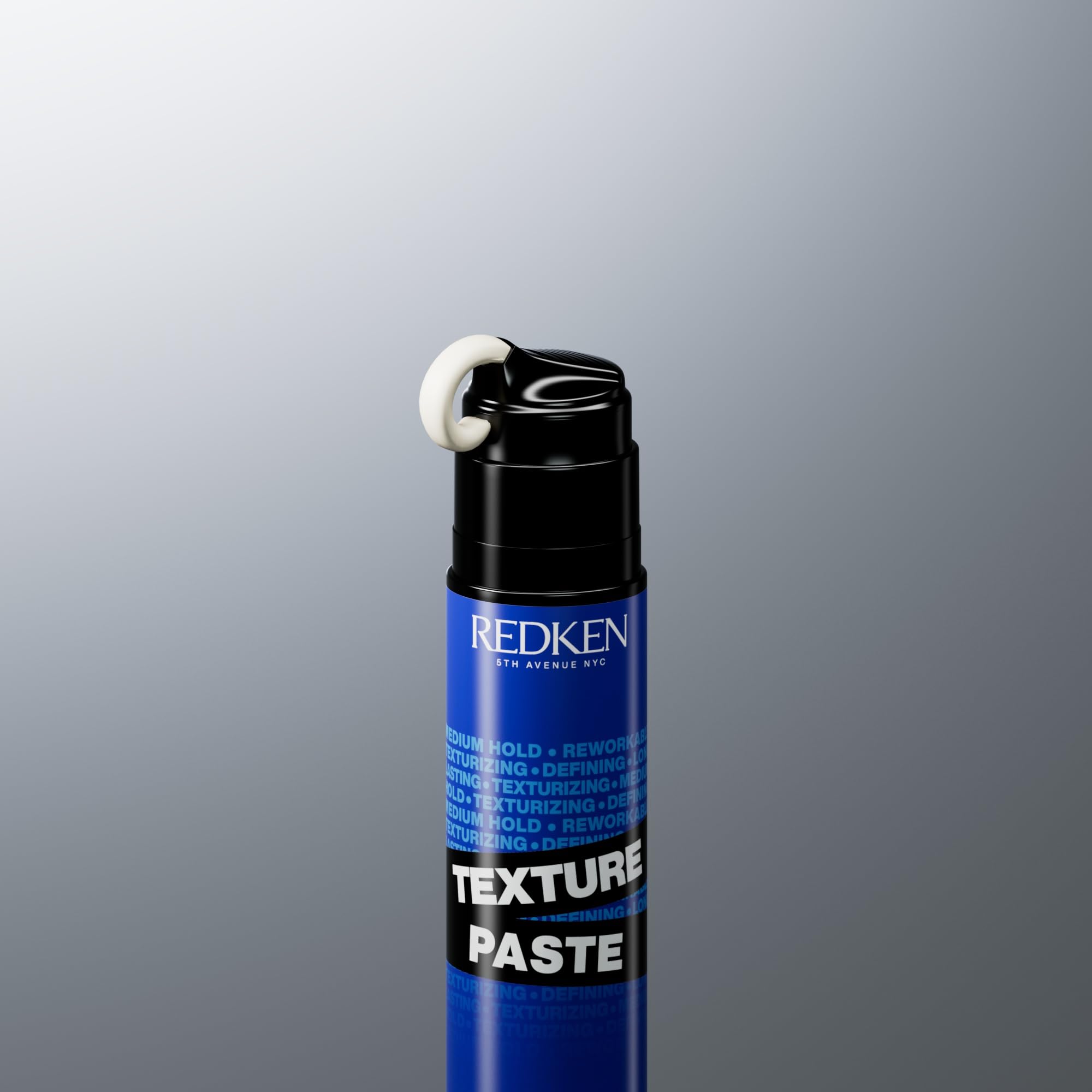 Redken 3.4 oz jar beside common objects showing true size and portability