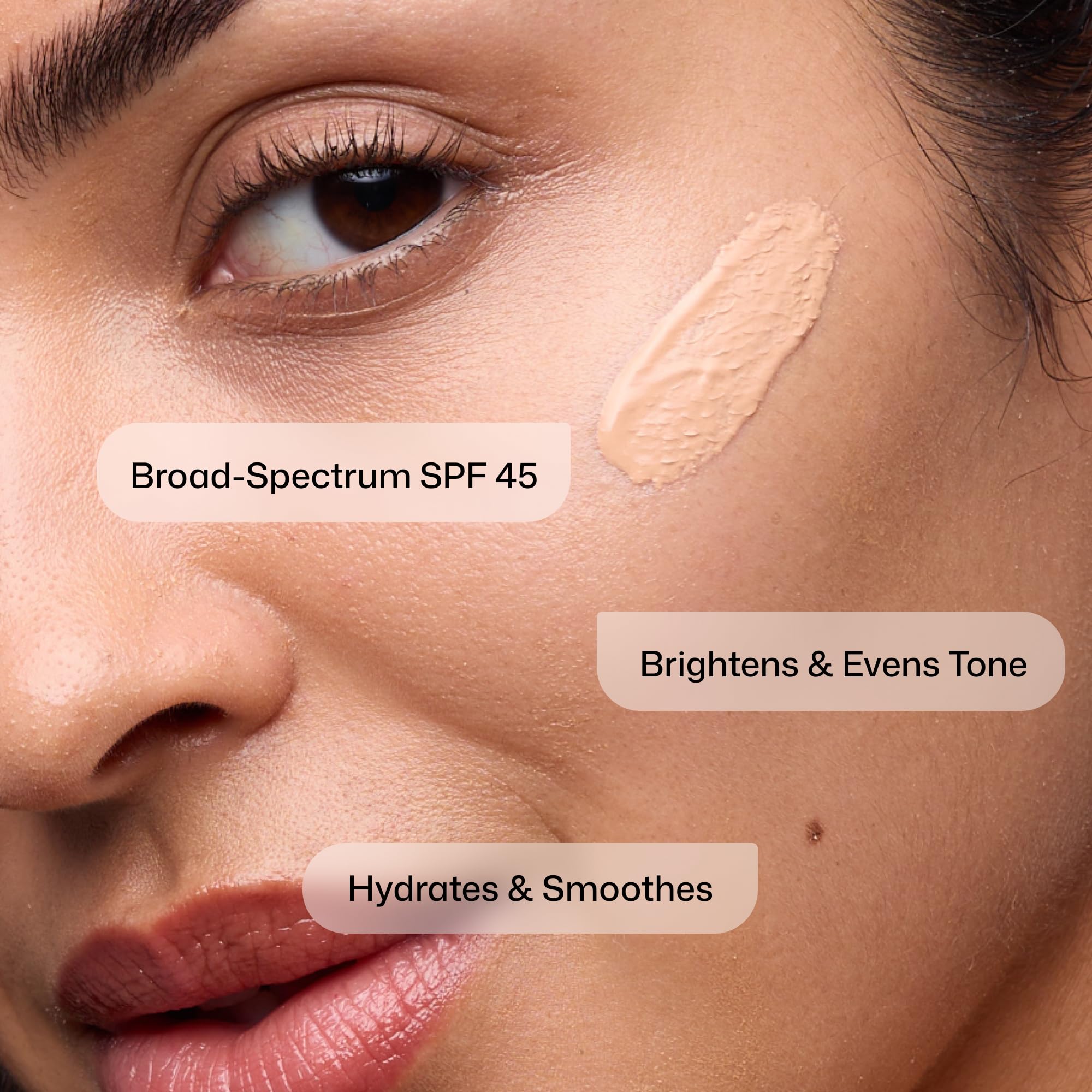 Revision Intellishade applied on cheek close-up showing sheer coverage and natural look benefit