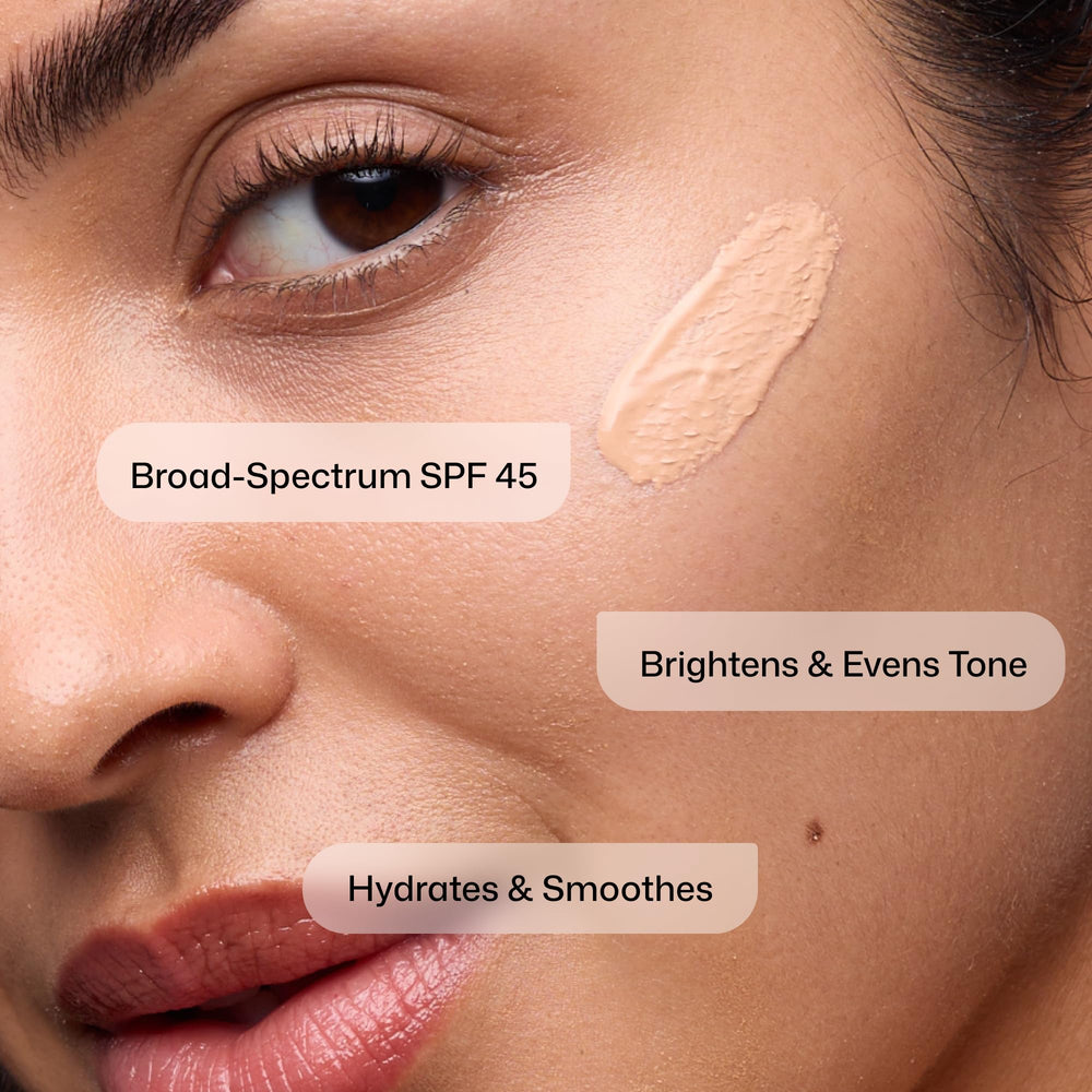 Revision Intellishade applied on cheek close-up showing sheer coverage and natural look benefit