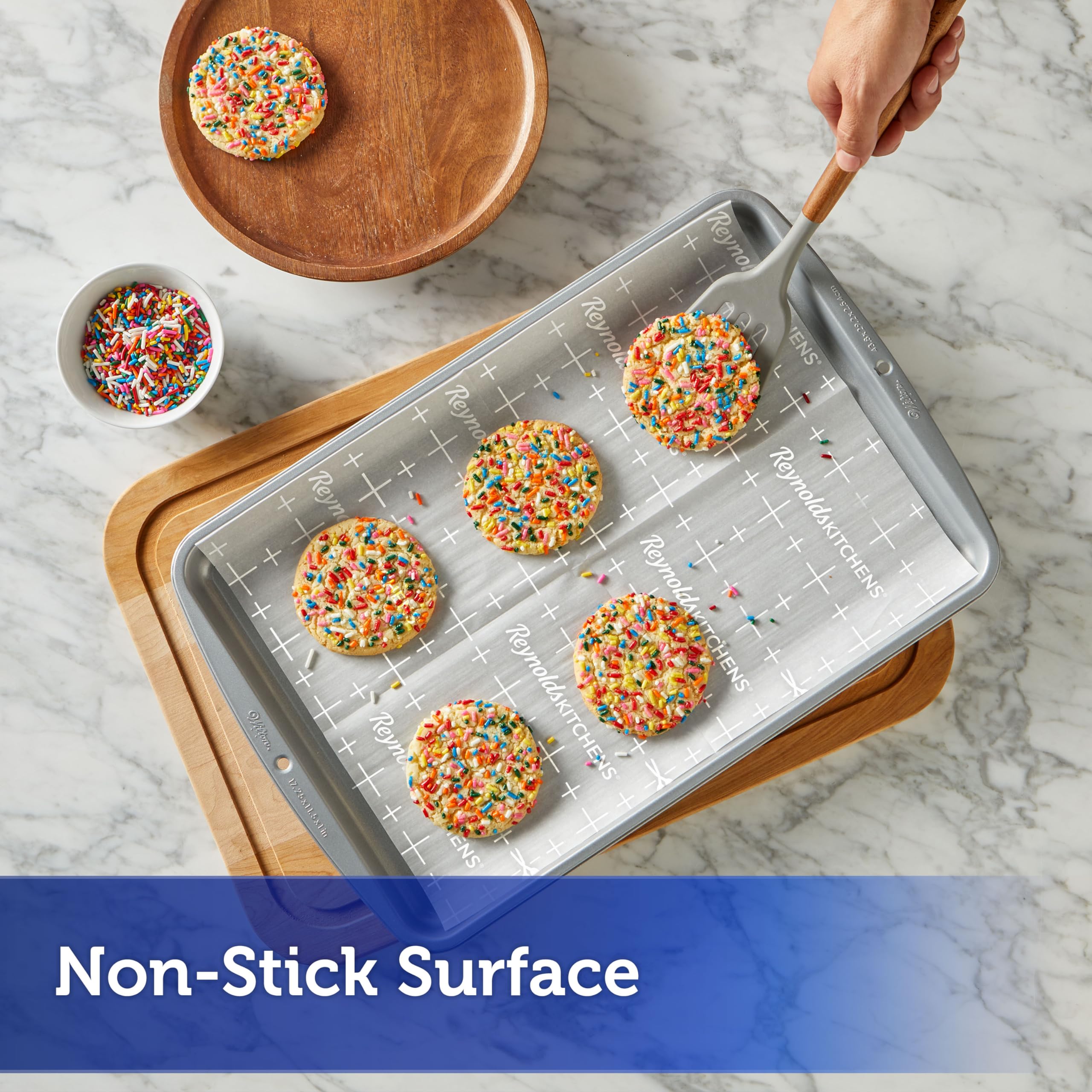 Reynolds sheet beside pan showing 12x16 size for easy fit on standard cookie sheets