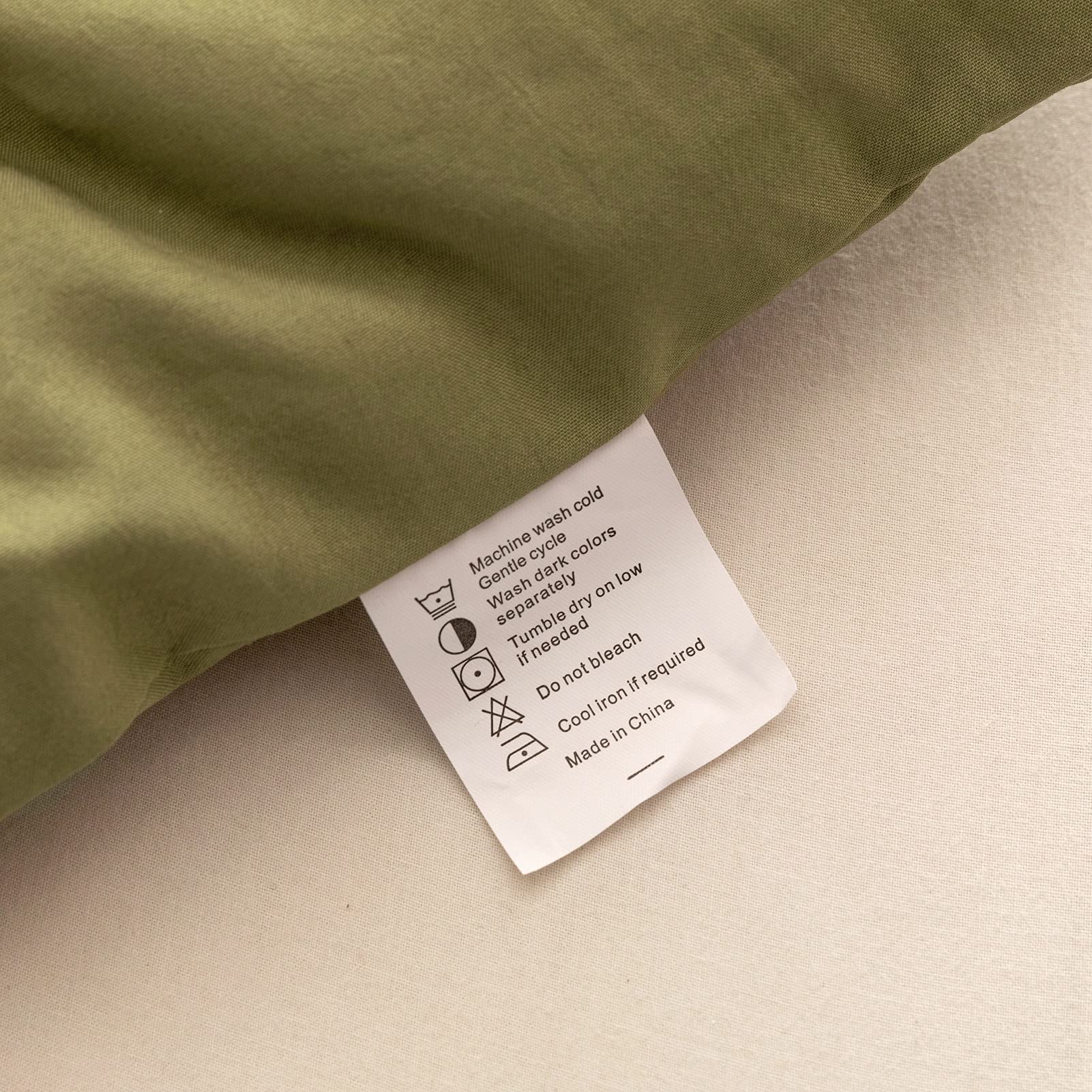 ROSGONIA styled bedroom featuring olive comforter offering calming ambiance