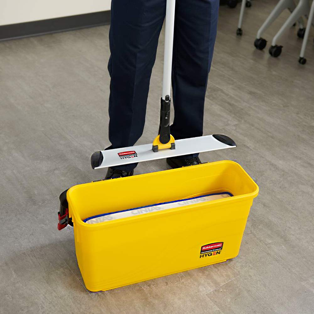 Rubbermaid Commercial HYGEN next to a traditional bucket showing space-saving and portability benefit