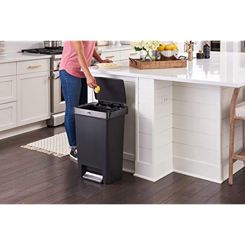 Rubbermaid trash can in kitchen next to cabinets to show 12.4 gallon scale