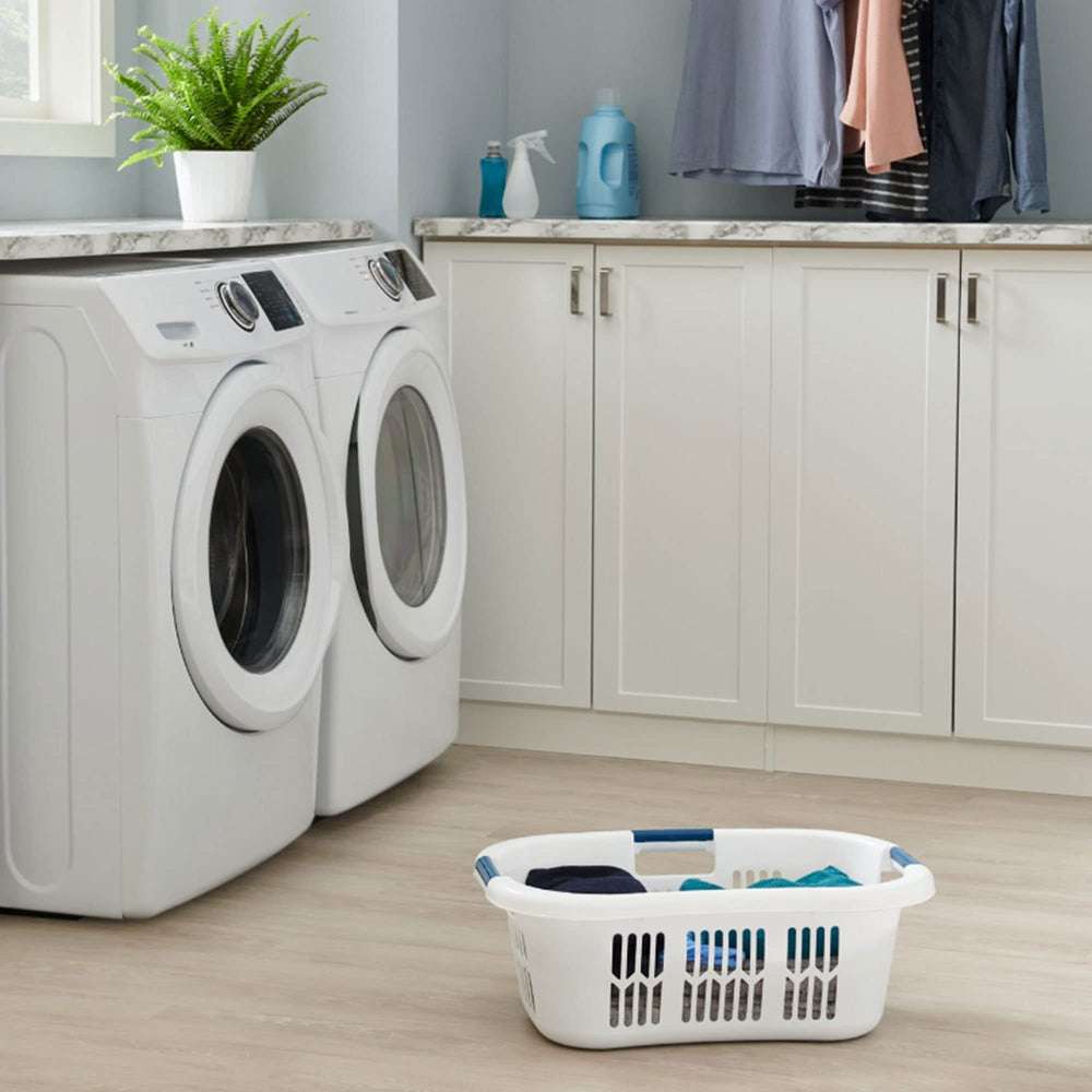Rubbermaid basket next to folded towels demonstrating 2.1-bushel capacity