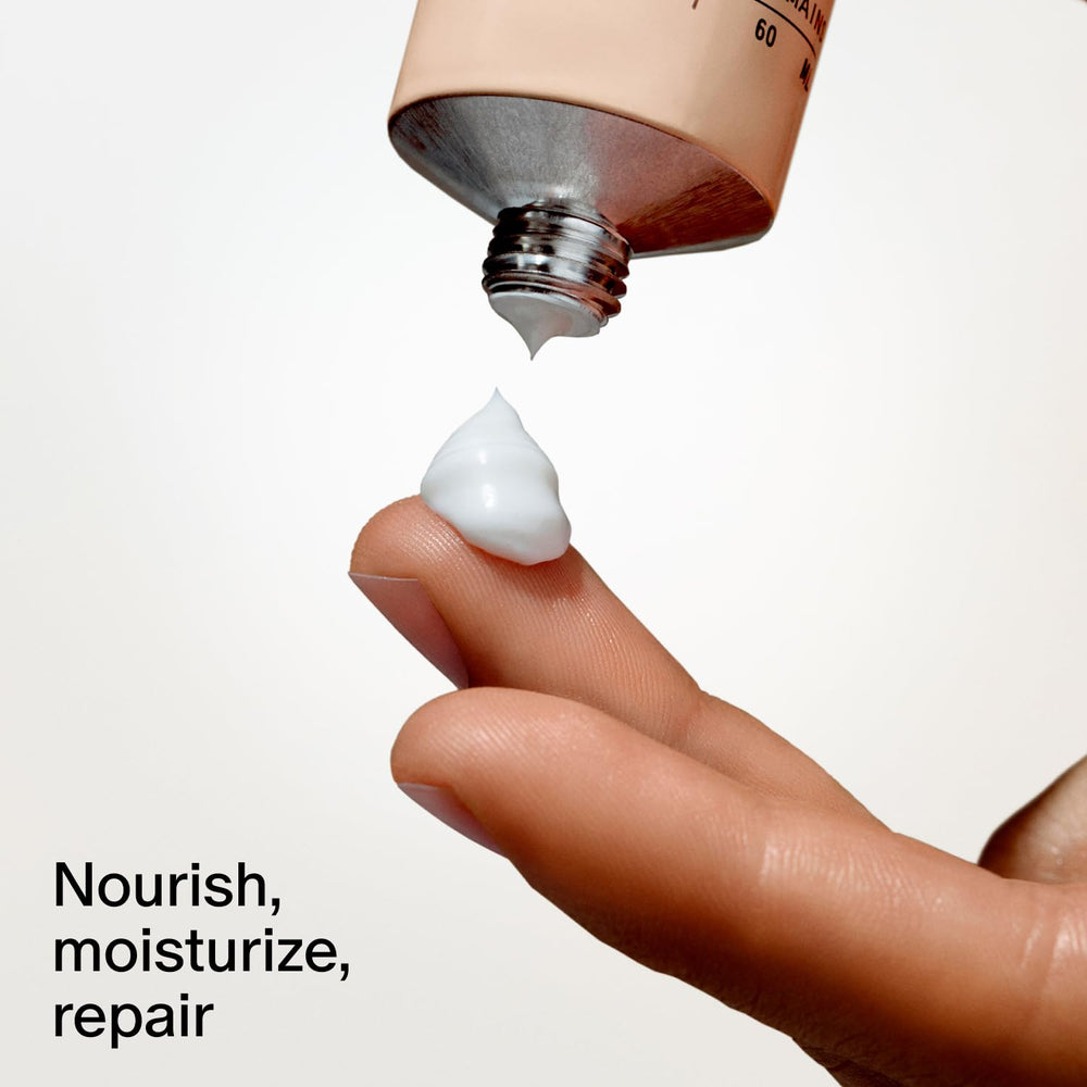Salt & Stone tube next to phone illustrating 2 fl oz travel-friendly size
