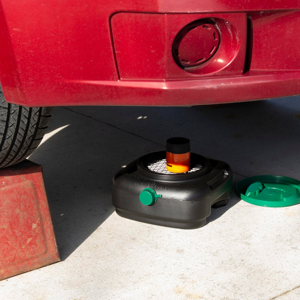 Scepter oil pan in use under vehicle capturing fluids for cleaner maintenance