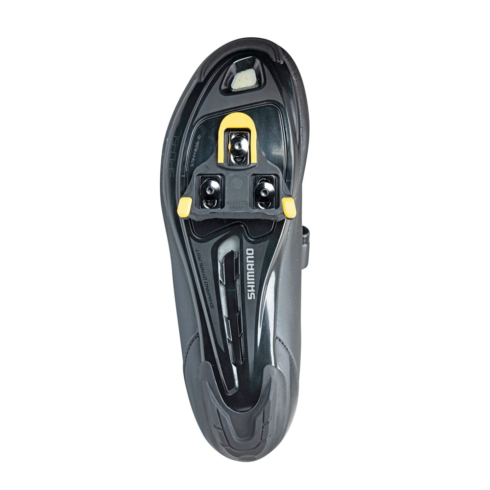 SHIMANO SM-SH11 next to ruler showing scale and standard 3-bolt road shoe fit