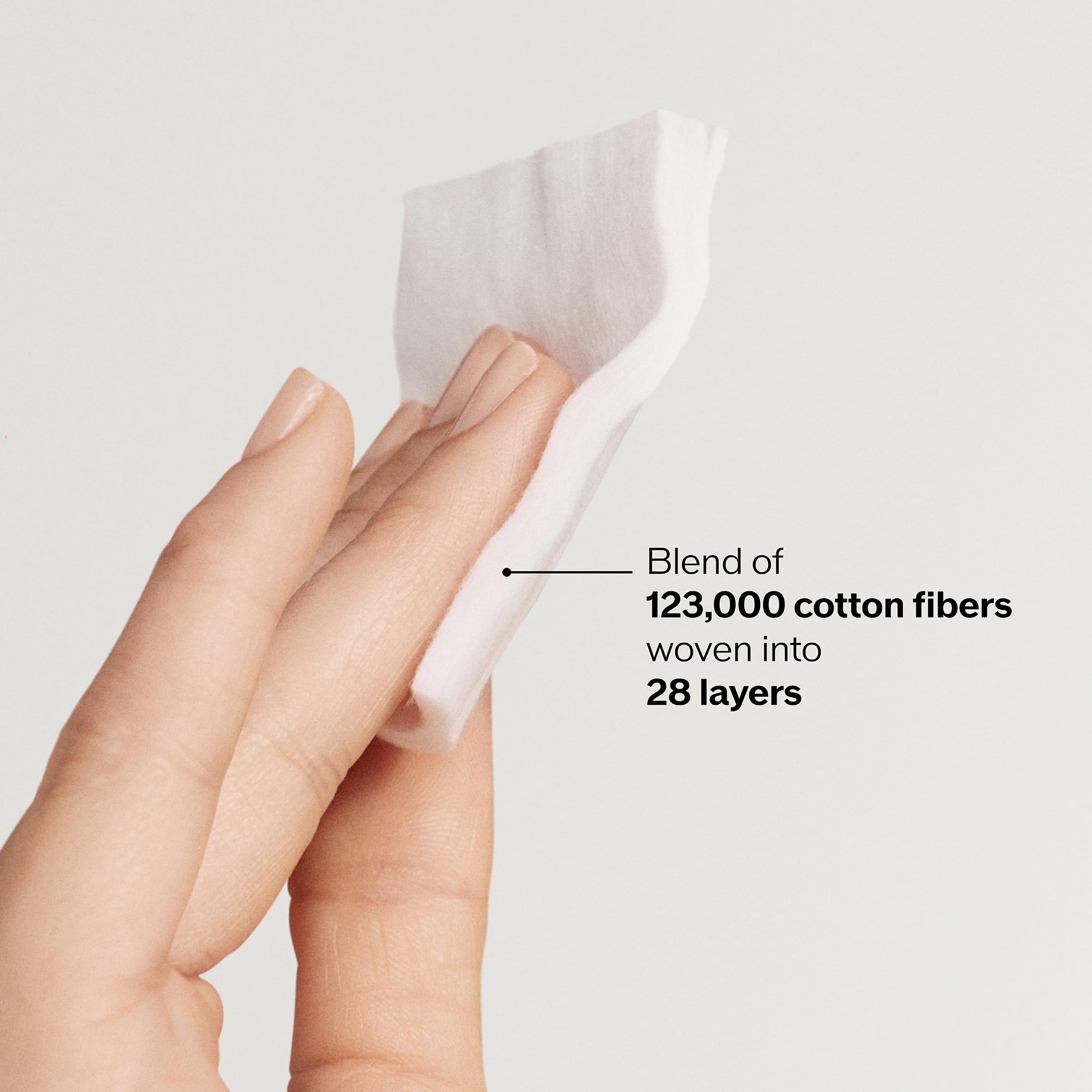 Hand holding a Shiseido pad to show size and easy application