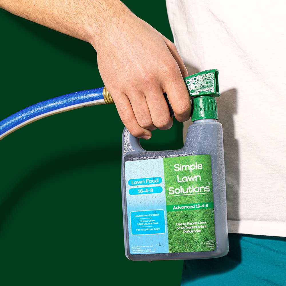 Simple Lawn Solutions 32 ounce bottle next to a hand for size reference