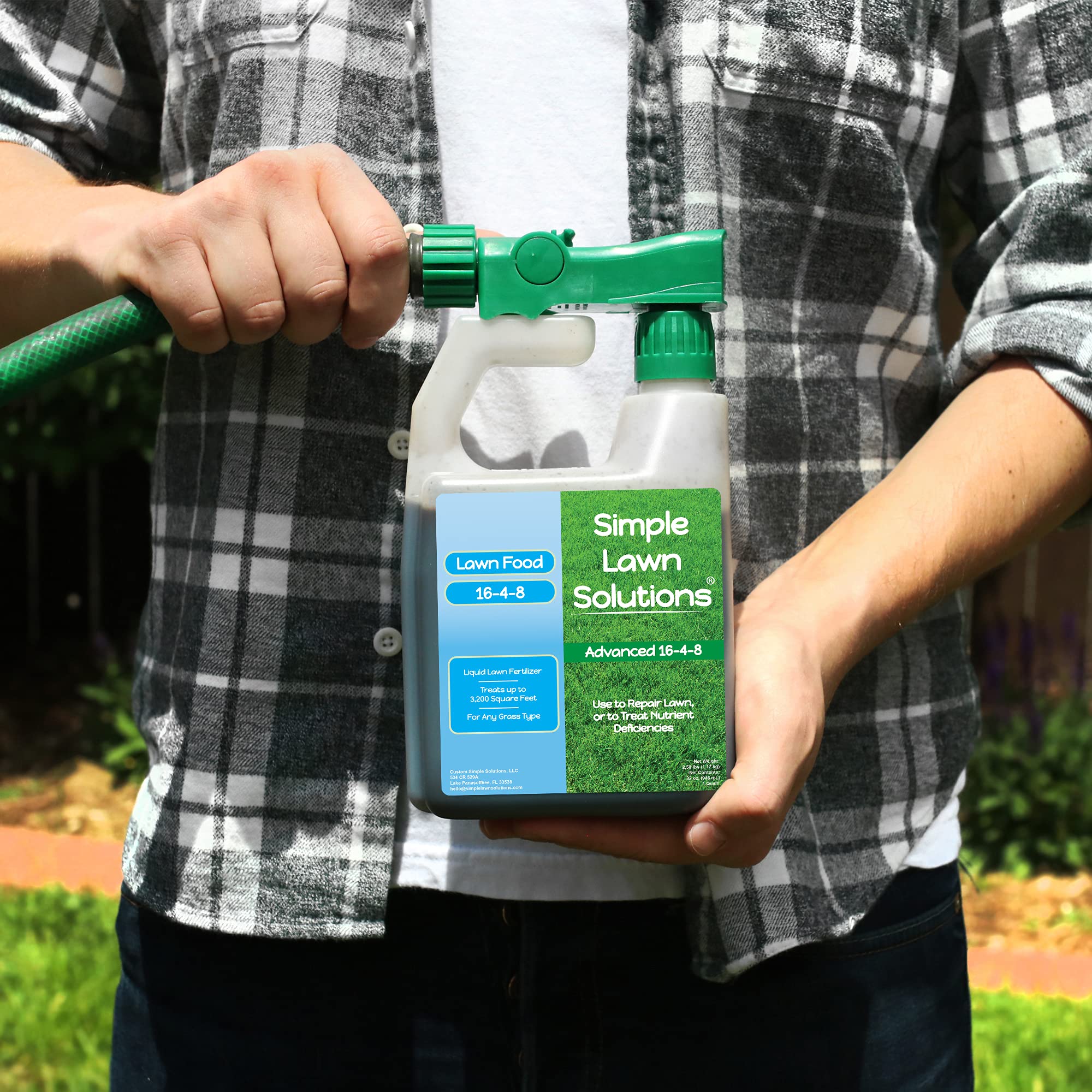 Simple Lawn Solutions bottle in hand ready to spray for fast application