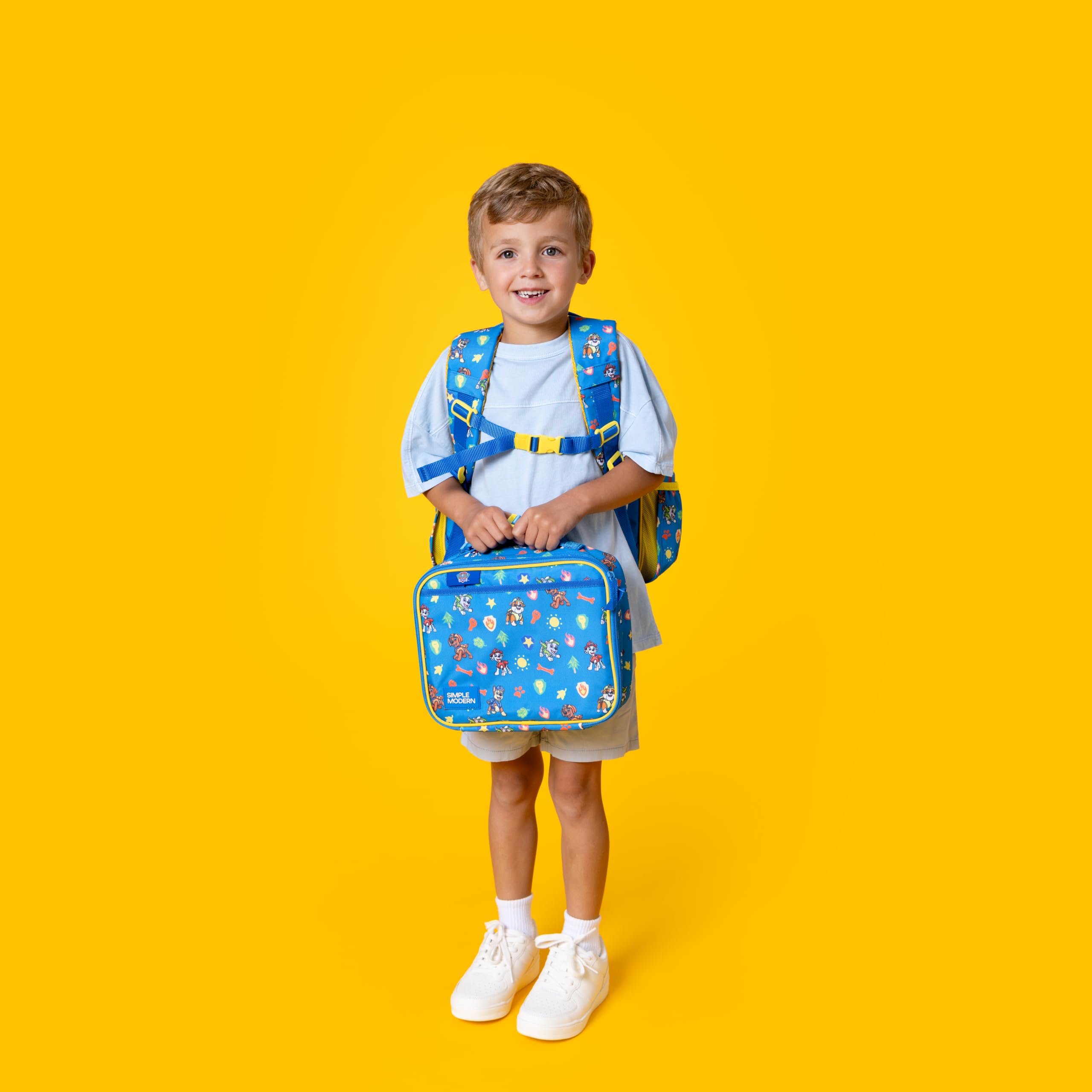 Child placing Hadley lunch bag into a Fletcher backpack for school readiness