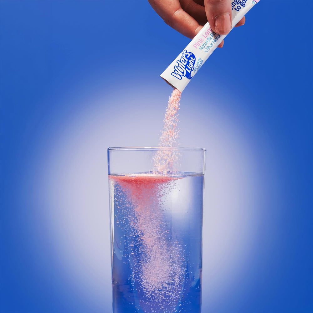 SINGLES TO GO! packet being poured into water to show quick mixing