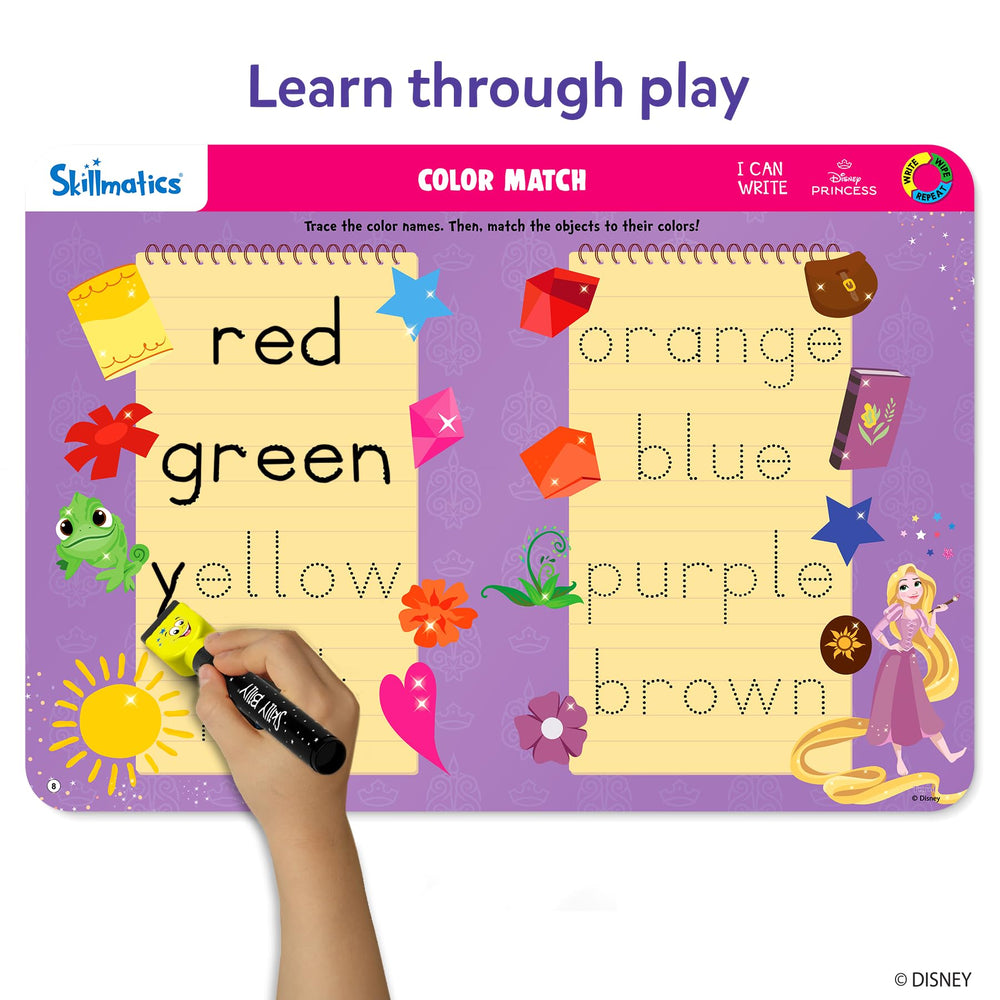 Child tracing letters on a Skillmatics mat with a marker, building handwriting skills