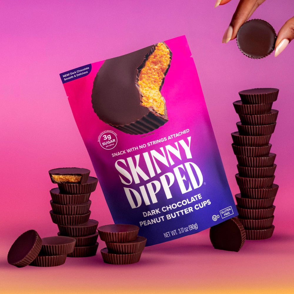 SKINNYDIPPED cup held in hand to demonstrate true-to-scale portion size for snacking control