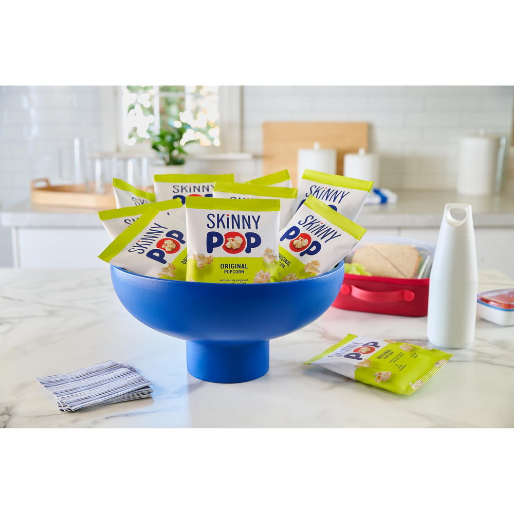 SKINNYPOP bag held in hand showing compact 1-ounce travel size
