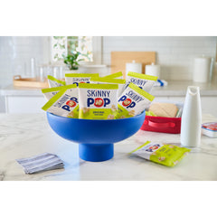 SKINNYPOP bag held in hand showing compact 1-ounce travel size