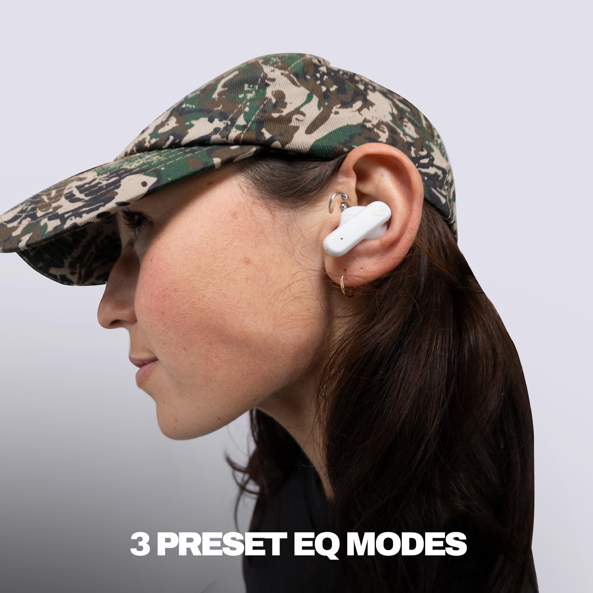 Skullcandy Smokin’ Buds next to smartphone showing compact size and portability