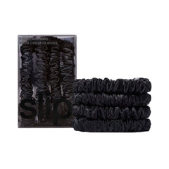 SLIP front packaging showing four black skinny silk scrunchies, refined presentation benefit
