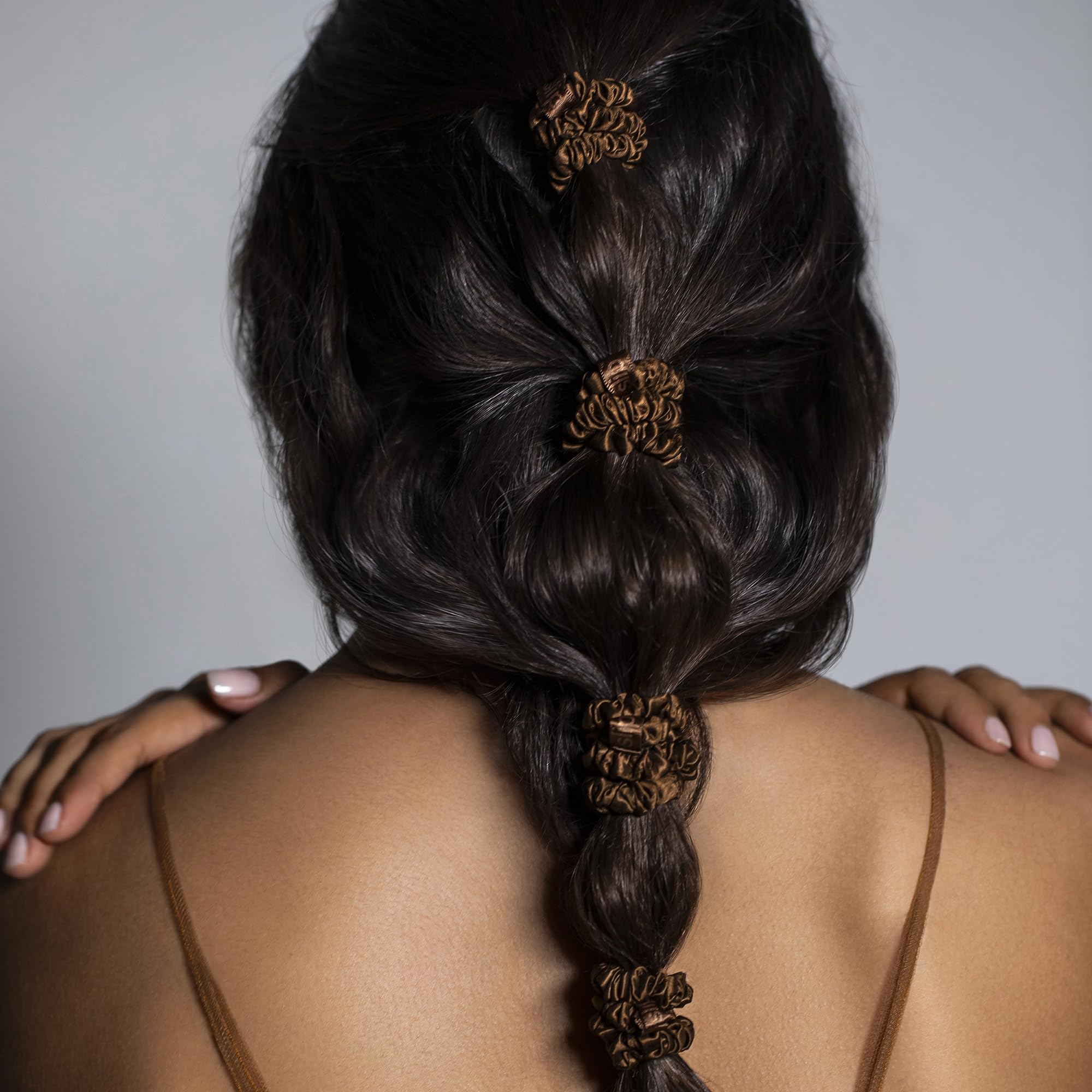SLIP scrunchie on bedside surface emphasizing night-safe, gentle hair care